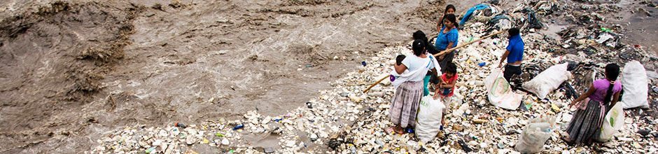 People standing at polluted bank of a river